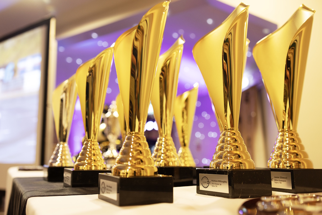 Gold end of season trophies on a table at the awards dinner